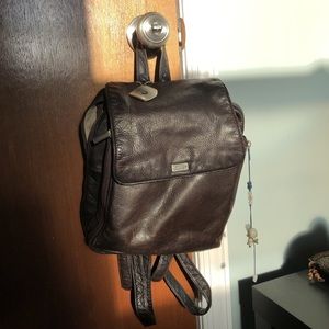 Brown leather stone and mountain mini backpack.
